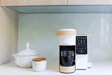 coffeemaker near sugar dish and white dish