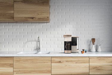 bruvi coffee system and B-Pods in kitchen with white brick backsplash and light wood cabinets