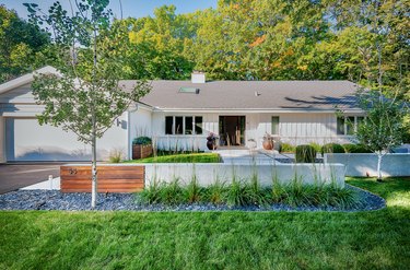 white contemporary ranch home with board and batten siding