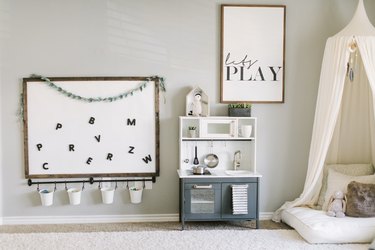 Playroom Organization Ideas with magnetic board and rail bucket system