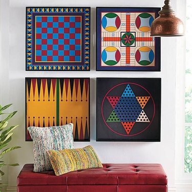 board game storage hanging on a wall over an ottoman