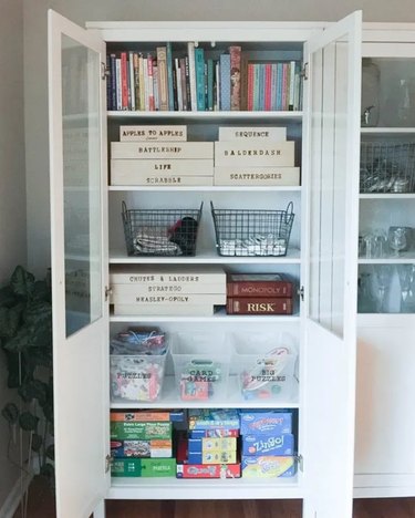 white bookcase for board game storage on the shelves