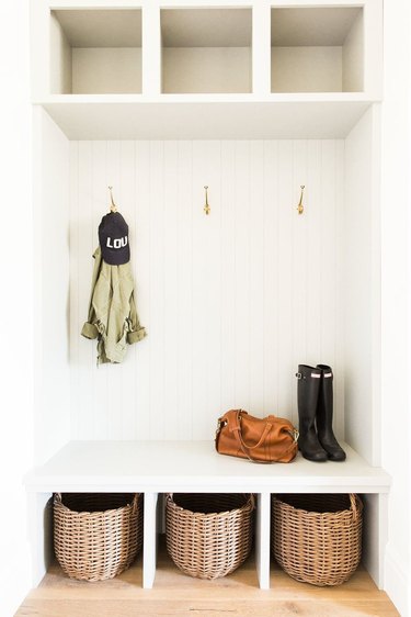 mudroom storage unit with baskets underneath seats