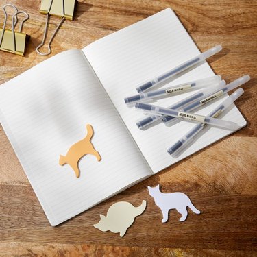 notebook with pens and cat-shaped sticky notes