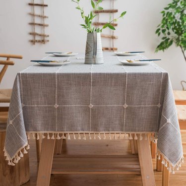 gray and cream grid tablecloth with tassels