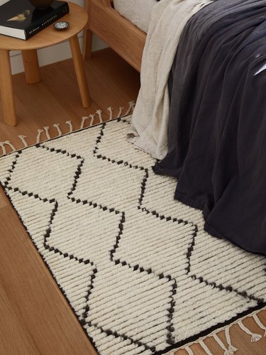 geometric rug next to bed