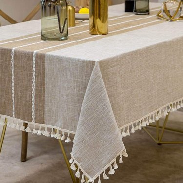 brown and tan indoor/outdoor table cover with tassels