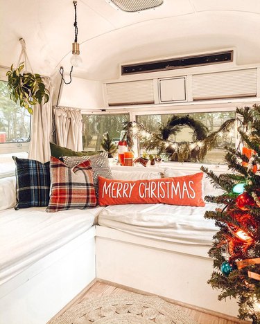 van with couch and holiday-themed pillows