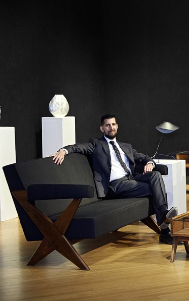 Jason Stein, Director of Modern Decorative Art + Design at Bonhams Los Angeles sitting on a couch