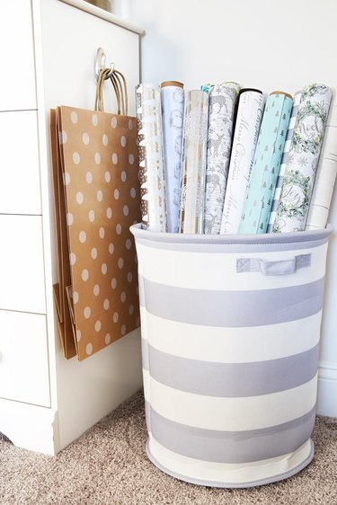 wrapping paper in striped laundry hamper