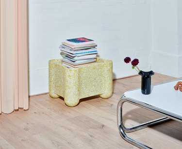 yellow crate with books in living room area