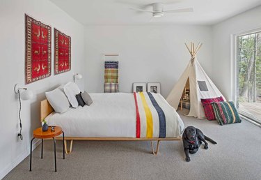 Kids rooms with teepee and Hudson Bay blanket on bed