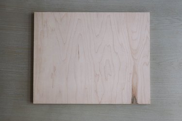Plywood board cut to size of tray