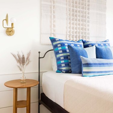 West Elm Local blue accent pillows on bed