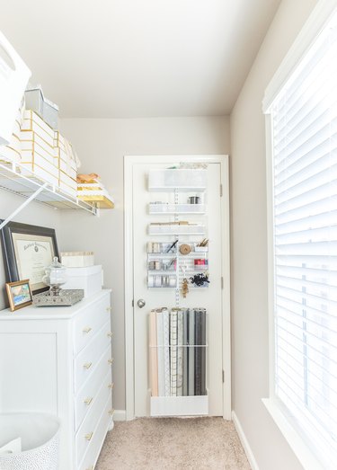 craft room with wrapping papper storage idea on back door