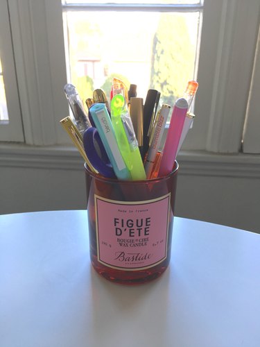 Bastide’s Figue d’Ete Candle as a pen holder on a white table