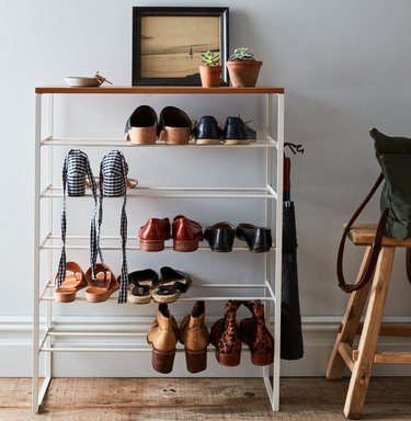 Closet Organizer with Metal and wood shoe rack, shoes, plants, photo.