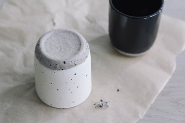 Painting speckled spots onto candle jar with thumbtack