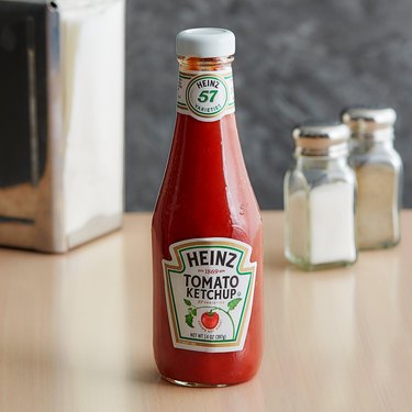 Heinz 14 oz. Ketchup glass bottle on countertop with salt and pepper