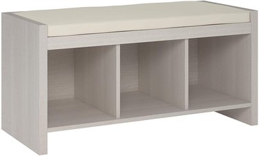 gray bedroom storage bench with cushioned top and cubbies