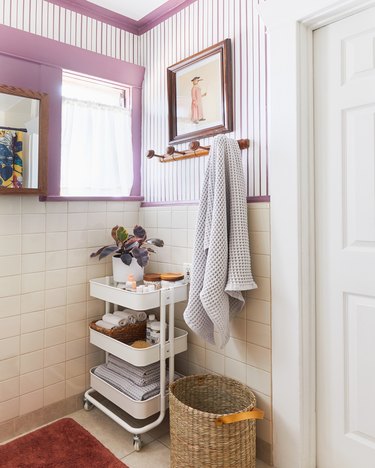 Modern bathroom storage with an IKEA utility cart designed by Emily Henderson