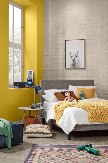 kids room with yellow wall and patterned rug