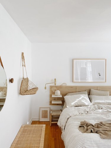 Sylvia Tribel  bedroom with IKEA headboard and brass wallsconces