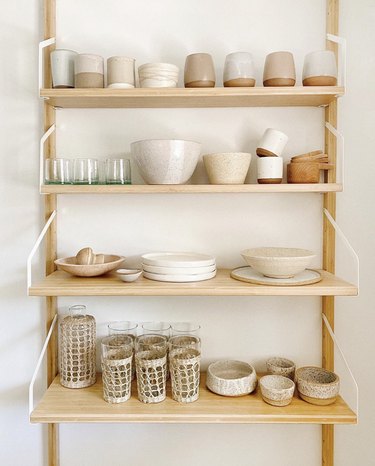 Sylvia Tribel  home with ceramic dishware on shelving