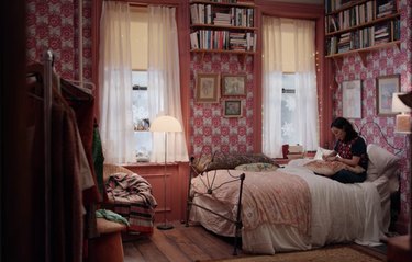 bedroom filled with books and pink decor