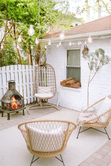 Sylvia Tribel  backyard seating area with string lights