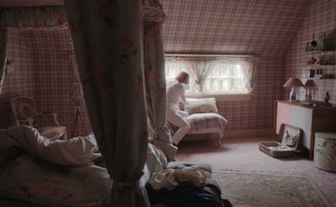 bedroom with canopy bed and pink wallpaper decor