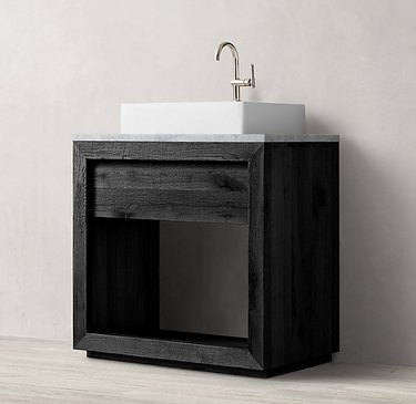 black industrial bathroom sink with white basin