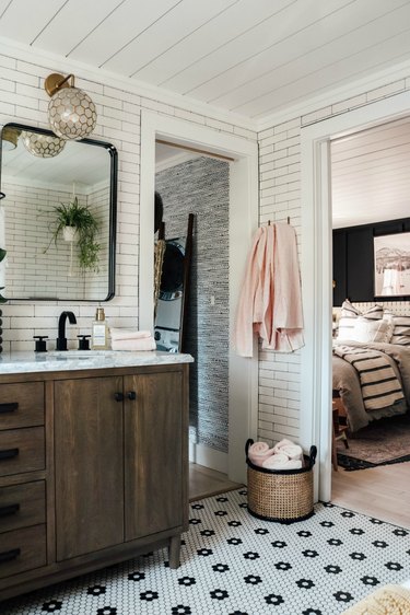 Boho Bathroom Storage in modern boho bathroom with patterned tiling and cane baskets