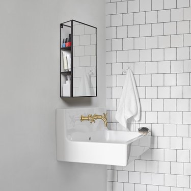 small minimalist bathroom with wall-mounted vanity that includes storage