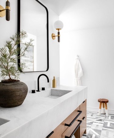 modern boho bathroom with marble counter and marble bathroom sink