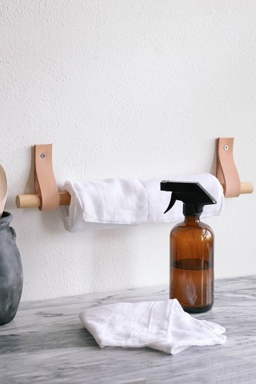 DIY unpaper towels hanging on wood and leather paper towel holder