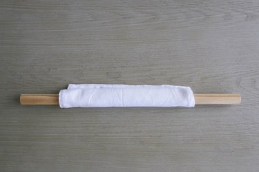 Rolling fabric unpaper towel around dowel