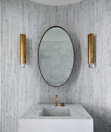 block marble bathroom sink against fluted marble wall