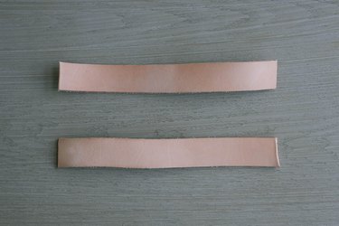 Two leather strips cut to 9-inch lengths