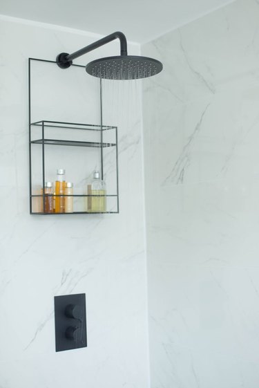 Black shower head with shower caddy and Scandinavian Bathroom Storage Ideas