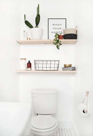 White toilet, wood shelves, plant, baskets and Scandinavian Bathroom Storage Ideas