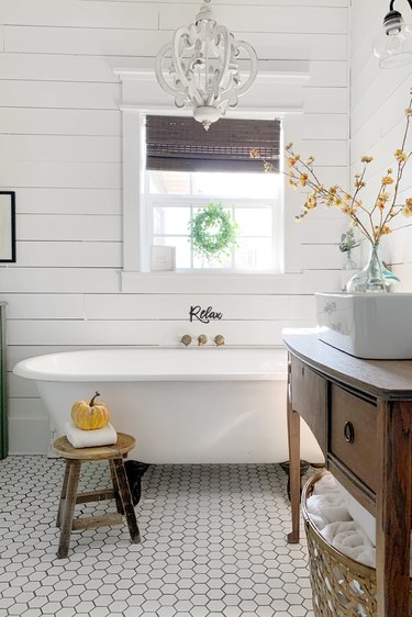 Farmhouse bathroom storage with shiplap walls and rustic decor