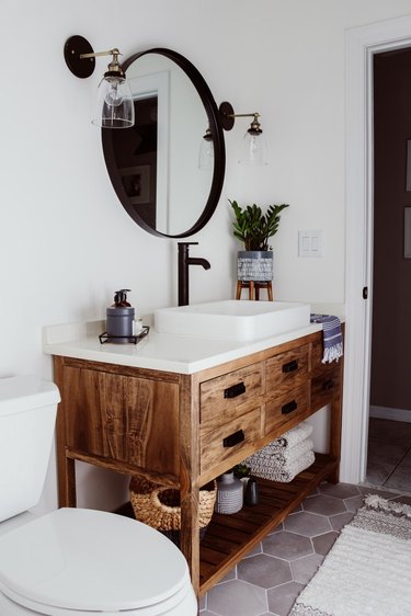 Farmhouse bathroom storage designed by Within the Grove with under the sink storage