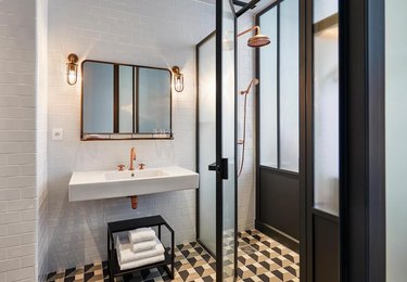 white hotel bathroom with frosted glass shower door