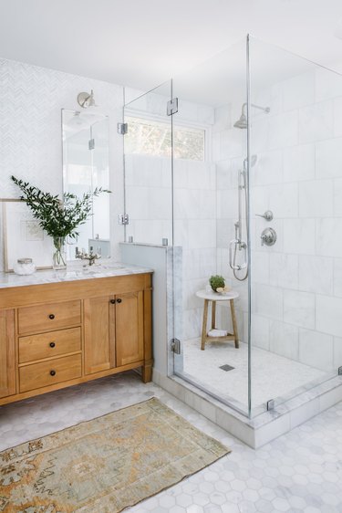 Corner shower with clear glass and marble wall tile