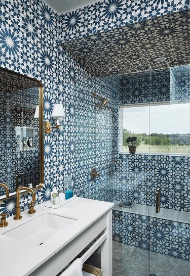 blue and white moroccan tiled bathroom and bohemian shower