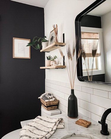 small modern bathroom with black accent wall