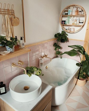 pink small modern bathroom with freestanding tub