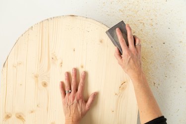 Sanding arched wood board