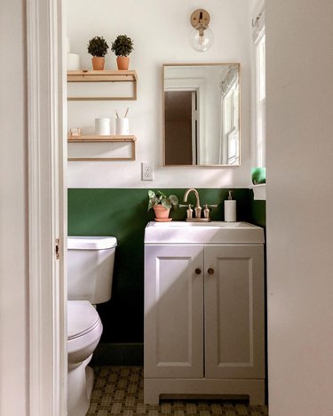 small modern bathroom with green accent wall